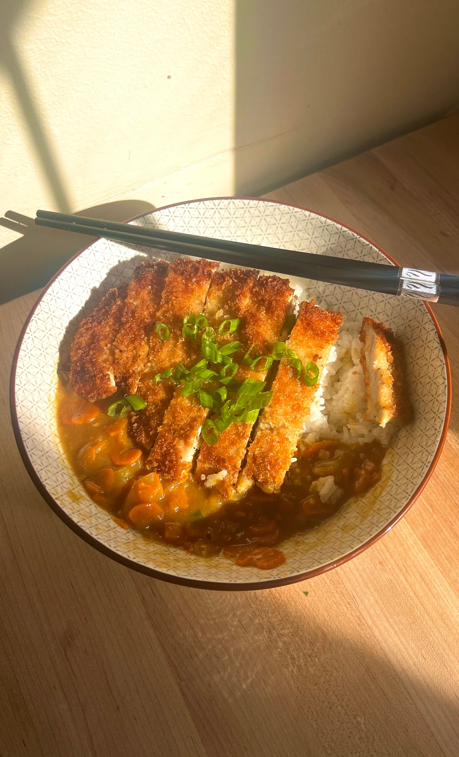 sliced chicken on curry and rice